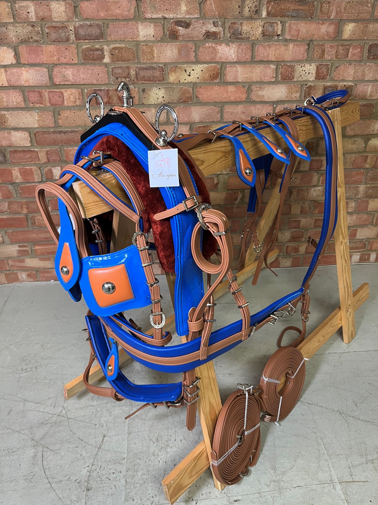 A brown and blue breeching harness for ponies horses and shetland