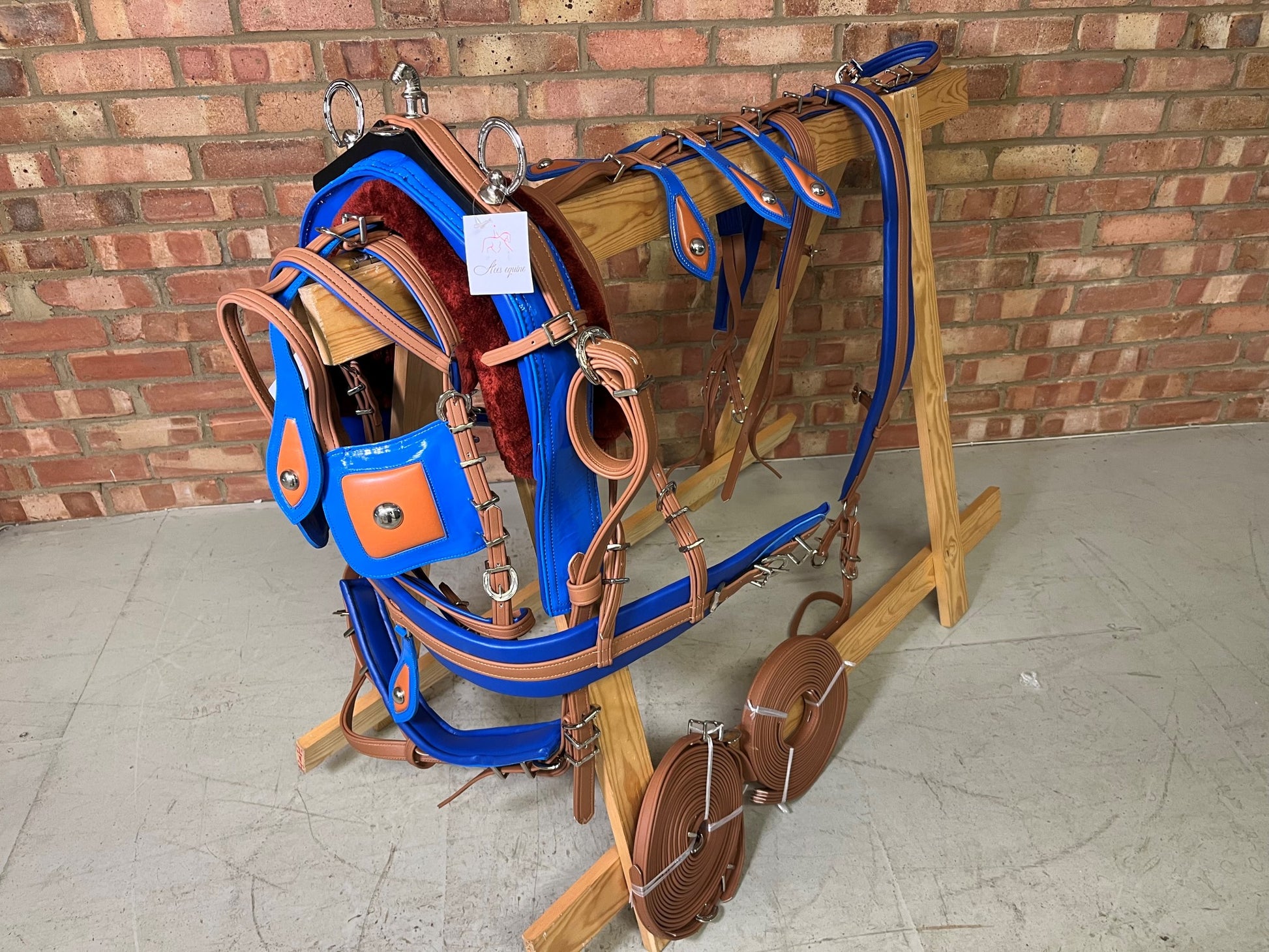 A brown and blue breeching harness for ponies horses and shetland